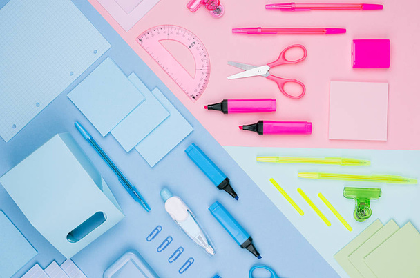 Back to school background - colored different stationery set on soft neon blue, pink, green paper background, top view. - Фото, изображение