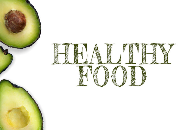 Avocado on a white background. Half-slices, half avocado. Nutrilon. Menu for cafe, healthy food, healthy fats. Place for text - Foto, Bild