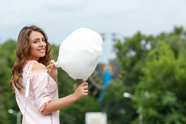 attractive woman holding sweet cotton candy - Φωτογραφία, εικόνα