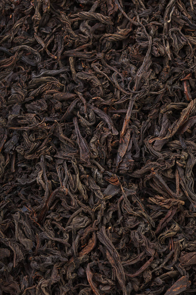 Dried tea leaves. Large leaf black tea. Close-up. - Photo, Image