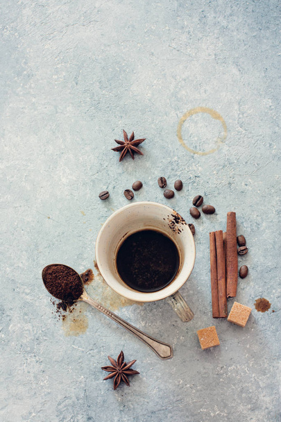 Empty Cup of Black Coffee , Coffee Beans,Brown Sugar and Cinnamon on Stone Background. Top View - Foto, Imagem