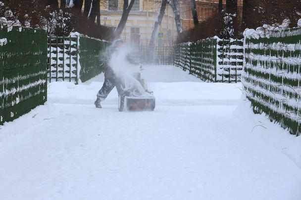 a man cleaning snow in the park with a snow-picker - Photo, Image