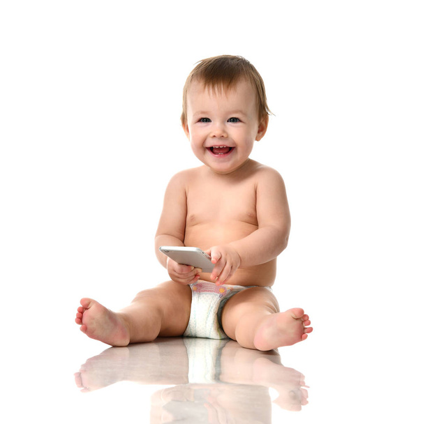 Infant child baby girl toddler playing with mobile cellphone happy smiling - Photo, image