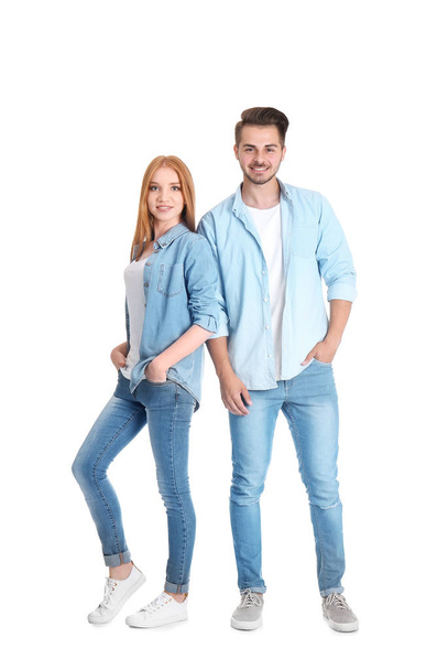 Young couple in stylish jeans on white background - Φωτογραφία, εικόνα