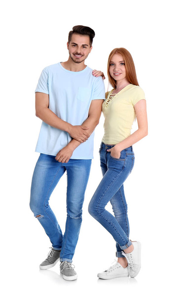 Young couple in stylish jeans on white background - Fotó, kép