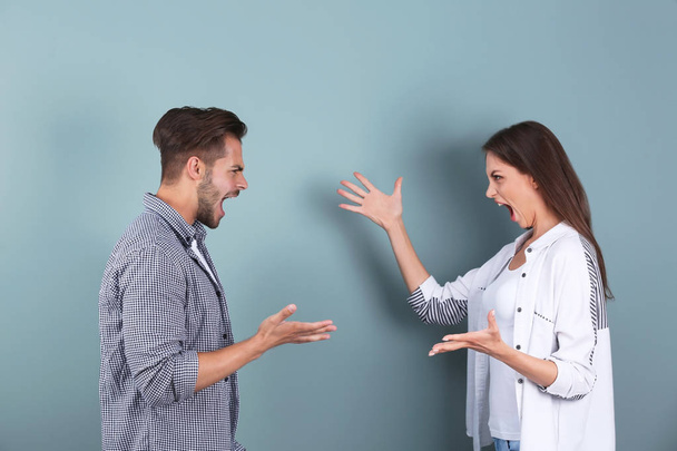 Young couple having argument on color background. Relationship problems - Photo, Image