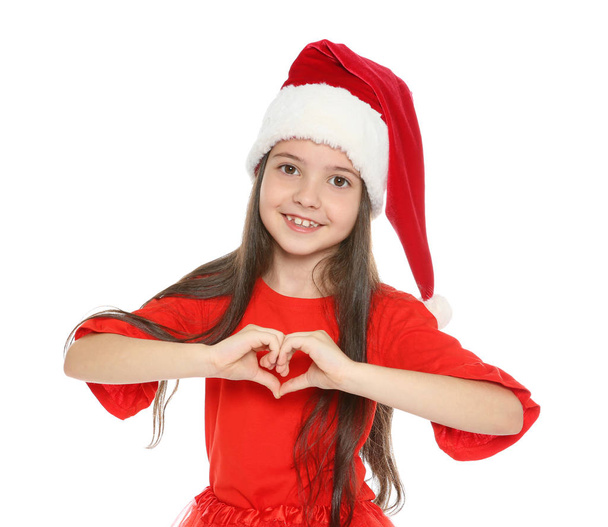 Cute little child in Santa hat posing on white background. Christmas celebration - 写真・画像