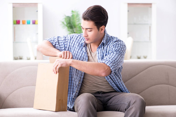 Man receiving parcel at home - Фото, зображення
