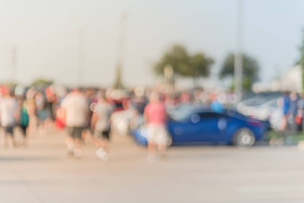 Blurred motion diverse group of people attending local car show in Dallas, Texas, USA. Busy people browsing cars of all years, makes, and models. - Photo, Image