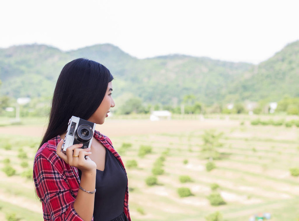 Young hipster woman photographer holding a vintage camera.  - Photo, Image