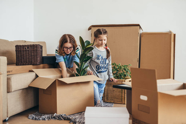 Woman and her daughters moving in new home - Foto, Bild