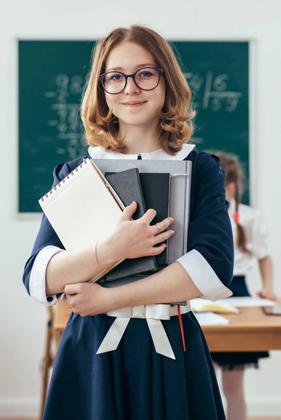 Portrait of smiling school girl with books - Valokuva, kuva