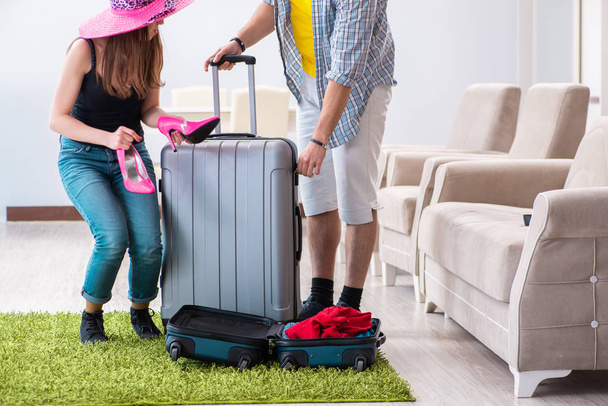 Young family packing for vacation travel - 写真・画像