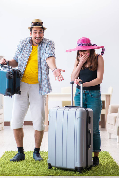 Young family packing for vacation travel - Valokuva, kuva