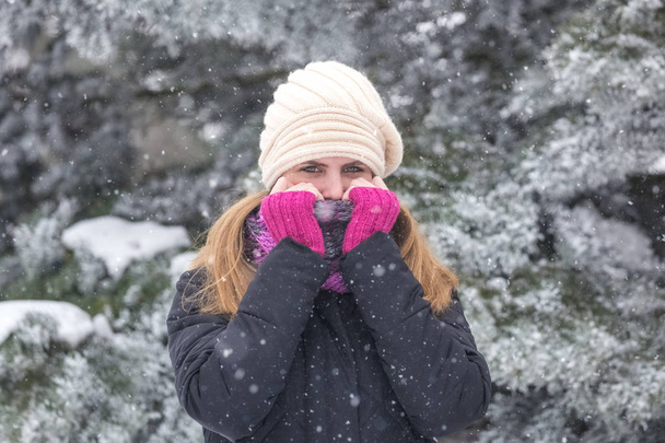 Portrait of young woman with scarf over her mouth on winter day. - Foto, immagini