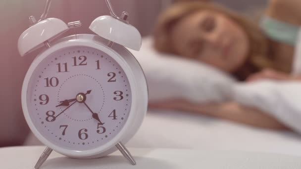 Healthy sleep of blond woman lying in bed in morning, biorhythms, closeup - Кадри, відео