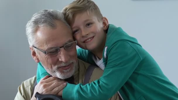 Happy retired man hugging with grandchild, enjoying free time together, family - Кадры, видео