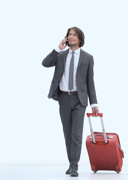 successful businessman with Luggage talking on the phone. - Фото, зображення