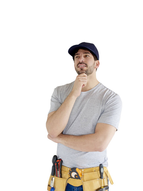 Portrait of young handyman looking thoughtful while standing with hand on his chin at isolated white background with copy space.  - Foto, immagini