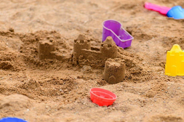 colorful toys in the sandbox on a sunny day, shallow depth of fi - Foto, Imagen