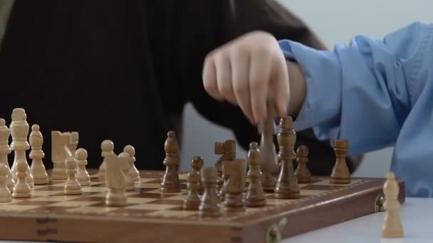 Boy playing chess with grandfather, leisure activity, having fun together, hobby - Video