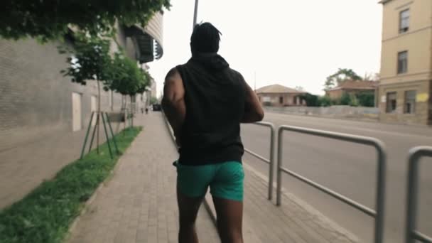 Man jogging in urban city place, back view - Кадры, видео