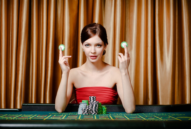 Woman with chips at the casino table - Foto, imagen