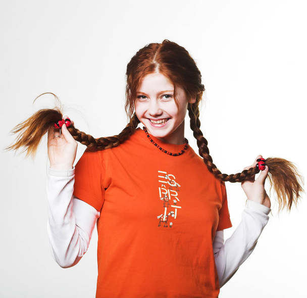 lovely redhead girl with long braids - 写真・画像