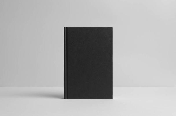 Black Hardcover Book Mock-Up - Front. Wall Background - Photo, image