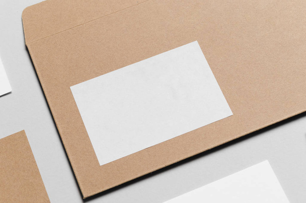 Branding / Stationery Mock-Up - Kraft & White. Close-Up - DL Envelope, Compliments Slip (99x210mm), Business Cards (85x55mm) - Photo, Image
