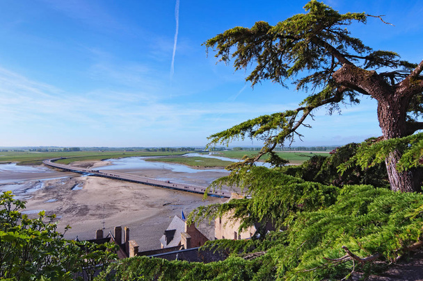 Wonderful wide angle view from walls of Mont Saint Michel abbey on the bay and bridge during the low tide. Normandy, France, Europe. - Photo, Image