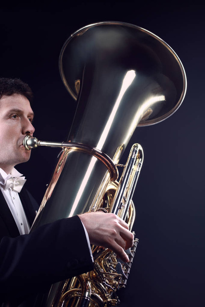 Tuba player brass instrument. Classical musician playing orchestra bass euphonium horn - Fotó, kép