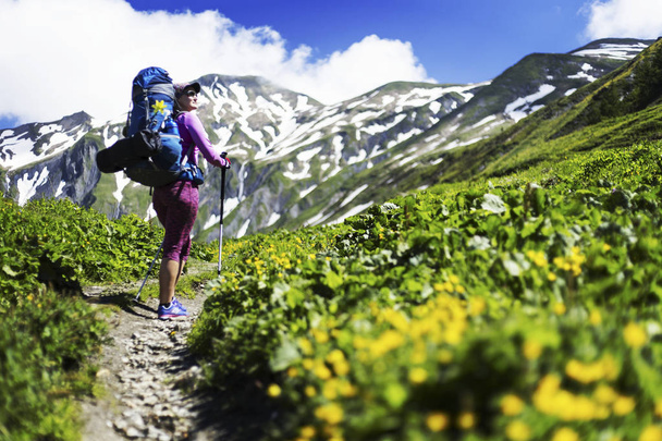 Campaign around Mont Blanc. The girl is walking along the trail with a backpack. - Photo, image