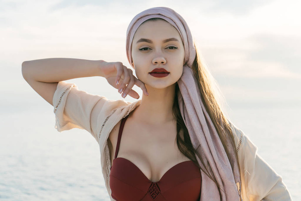 beautiful young girl with red lipstick enjoys a sea adventure on a yacht, poses - Valokuva, kuva