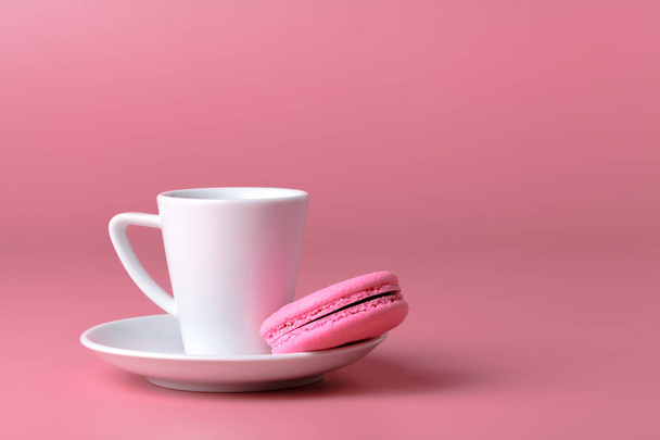 One pink macaroon with cup of coffee - Fotó, kép