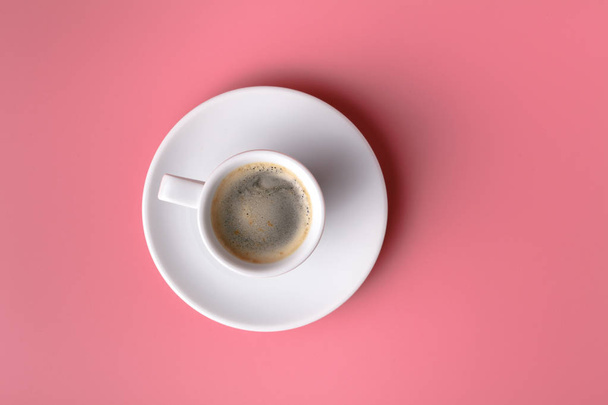 One small cup of coffee on pink background - Zdjęcie, obraz