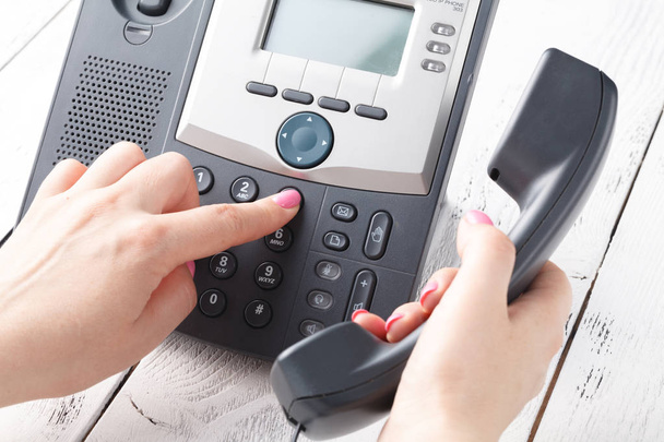 Call center or office phone concept, female finger press number on phonepad - Fotó, kép