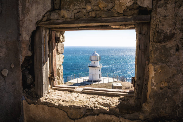 Lighthouse. View from an abandoned radio-transmission to a beacon. Cape Meganom. City district Sudak, the Republic of Crimea. - Foto, immagini