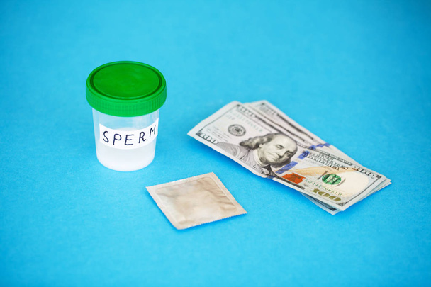 Health. Close up Concept of Bank Sperm. Infertility Bank with Sperm. Doctor's Hand Holds Container for Analyzes. Sperm Analysis on Blue Background. - Photo, Image