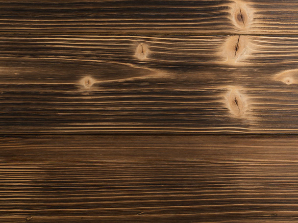 Old dark burnt wood background. Scorched wooden board plank texture. Natural rustic photo backdrop for vintage hipster design - Photo, Image