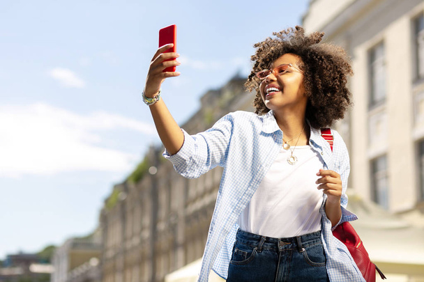 Cute curly woman taking selfies during excursion - Foto, immagini