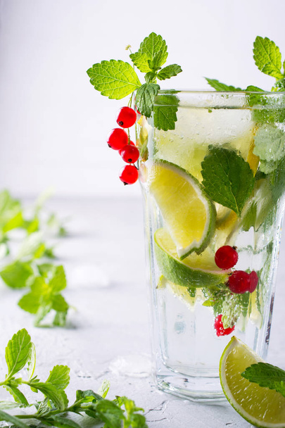 Cold summer homemade fruit and berries lemonade. Mojito, lemonade or sangria in glass.  - Foto, Imagen