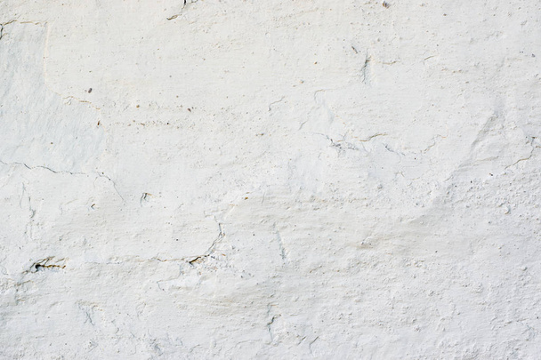 Closeup fragment of white shabby stone wall - Foto, afbeelding