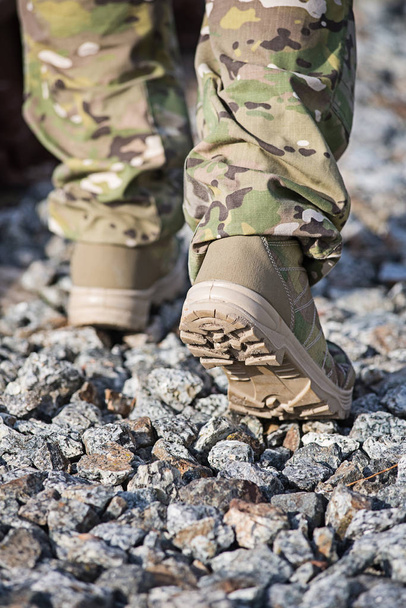 Soldier is walking on small stones, close-up. Selective focus - Photo, Image