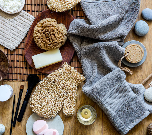 beauty mix of traditional and zen body care objects for genuine shower or bath with natural sponge, loofah, towel, solid soap and makeup brushes, top view - 写真・画像