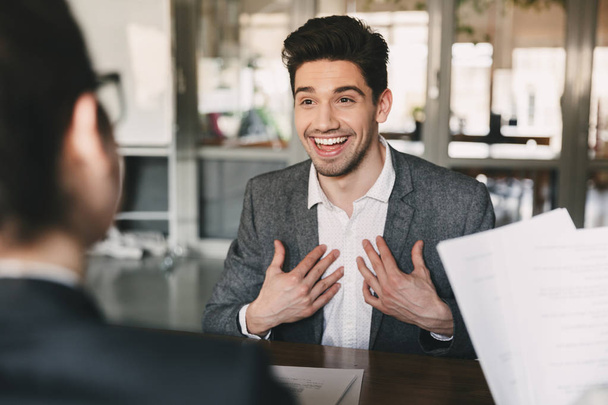 Business, career and placement concept - surprised caucasian man 30s rejoicing and showing at himself when hiring during job interview with employees in office - Fotoğraf, Görsel
