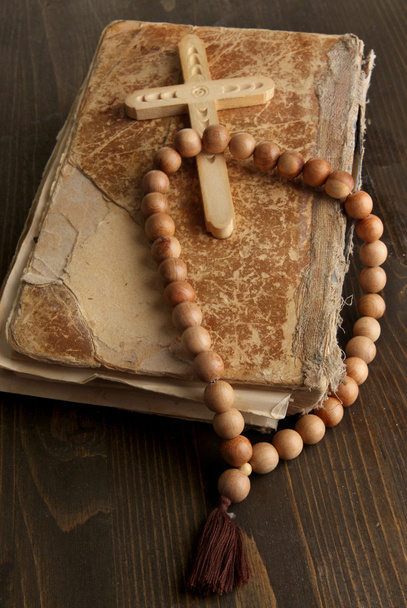 Bible, rosary and cross on wooden table close-up - Photo, Image