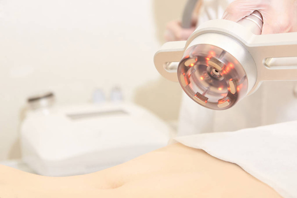 Body cavitation treatment. Ultrasound care to fat reduction. Beauty ultrasonic massage therapy at salon. Anti cellulite. - 写真・画像
