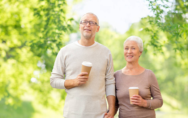 senior couple with coffee cups natural background - Photo, Image