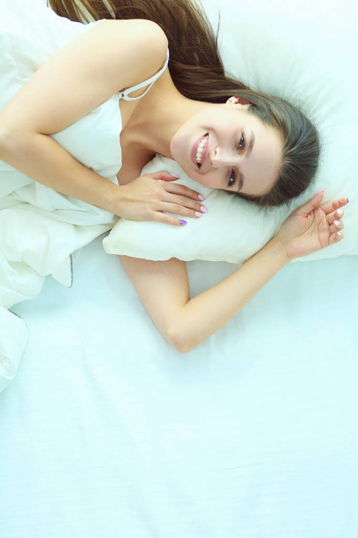 Beautiful girl sleeps in the bedroom, lying on bed. - Fotoğraf, Görsel